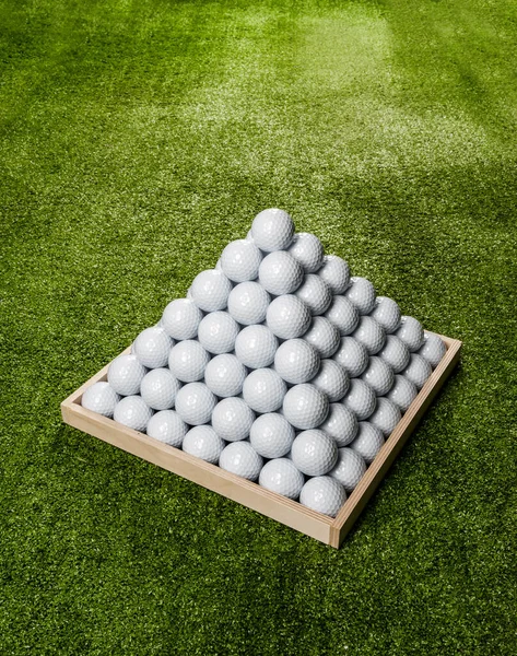 Pyramid of golf balls in a driving range, top view, vertical image