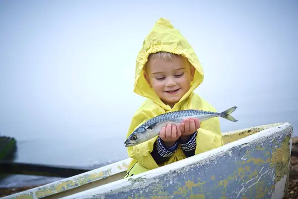 Toddler Boy Yellow Raincoat Holding Mackerel Fish Boat — Stock Photo, Image