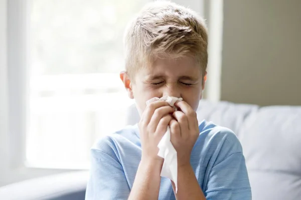 Preteen Boy Blowing Nose Indoors — Stok Foto