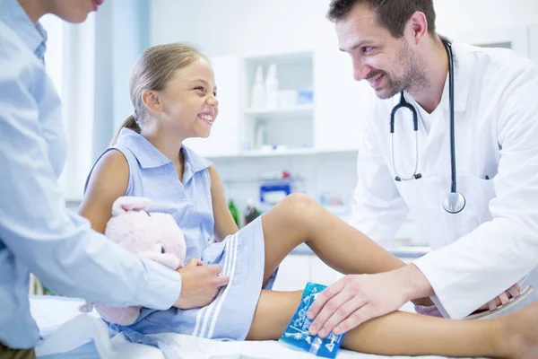 Médico Masculino Colocando Saco Gelo Perna Jovem Menina — Fotografia de Stock