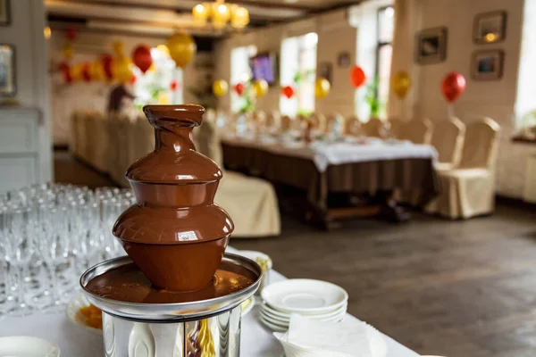 Chocolate fountain, fondue in the banquet hall Royalty Free Stock Images