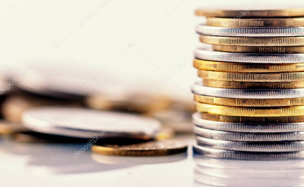 Pile of coins on blurred background