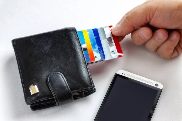 De hand trekt van zijn portemonnee met een credit card. — Stockfoto