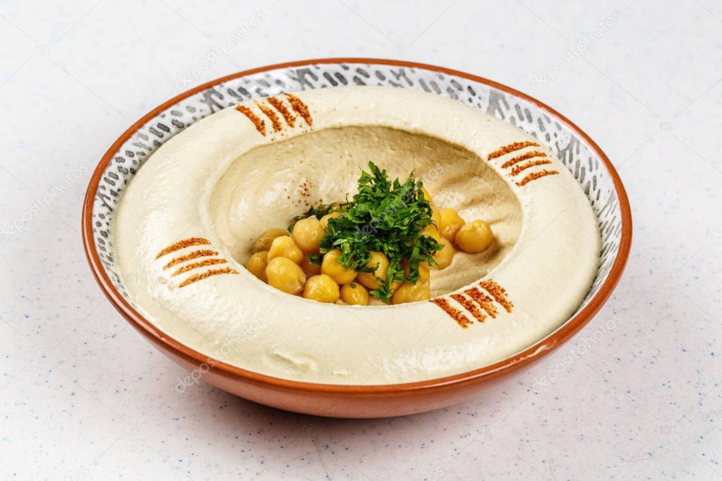Arabic food Hummus with parsley in a traditional bowl. — Stock Photo © Begelart 159597846