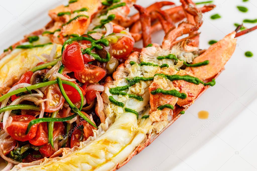 Italian cuisine. Whole lobster baked and sliced in half Served with