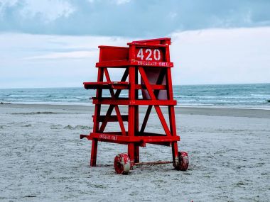 Red lifeguard stand on a deserted beach. clipart