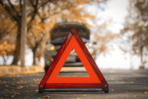 Authmn time. Red triangle, red emergency stop sign, red emergency symbol and  car stop and park on road.