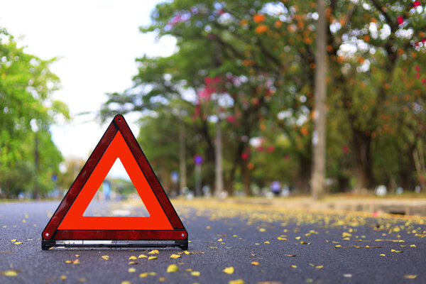 Red triangle, red emergency stop sign, red emergency symbol on road. With copy space for text or design