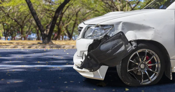 Front of white color car big damaged and broken by accident on city street parking can not drive any more. With copy space for text or design — Stock Photo, Image