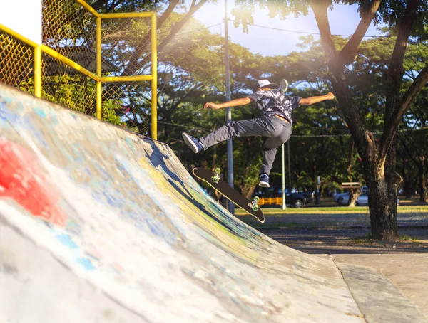 Young boy jump on ramp with skateboard outdoor. — Stock Photo, Image