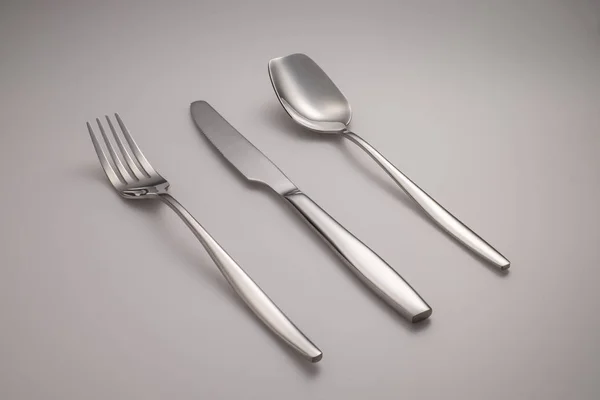 Flatware, cutlery set - fork and knife - black and white silhouette on grey background — Stock Photo, Image