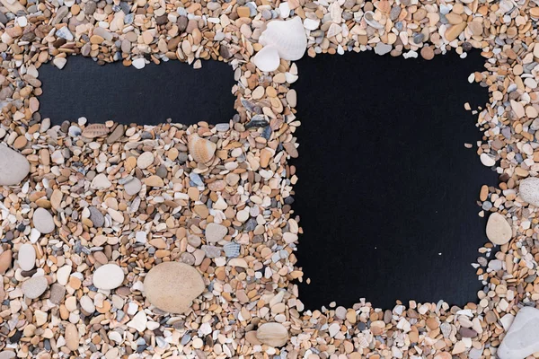 Calendar, menu and date from small sea stones and shells on a black background. Empty fields for filling in, notes with a table of contents.