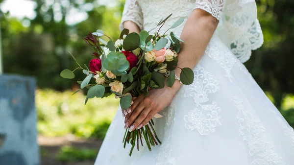 Bouquet in bride's hands — Stock Photo, Image