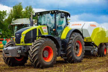 VINNITSA, UKRAINE - JULY 2017: CLAAS AXION 930 Modern agricultur