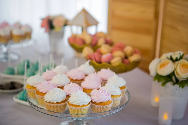 カップケーキ。結婚披露宴のおいしいカラフルなカップケーキや他イベント パーティー。結婚式のテーブル デコレーション。結婚式の棒キャンディ. — ストック写真