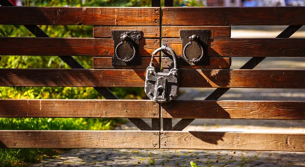 vintage lock on the gate of wooden boards. Gates in the forest