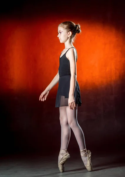 Premium Photo  Ballerina in a black body and white tights is sitting on  the wooden floor dancer touching her leg looking at camera on studio  background