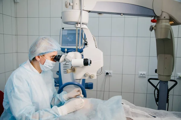 Surgeon with operating system of laser vision correction in the operating room. Ophthalmology operation process