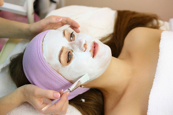Young woman gets beauty facial injections in salon. Aesthetic cosmetology.