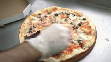 Şef'in el pizza restoran mutfağında yemek sonra pizza için baharat ekler. Yemek yemek.