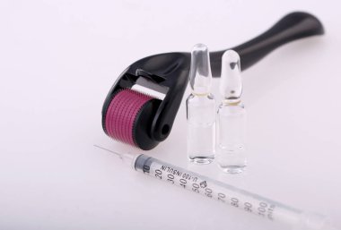 Derma roller for medical micro needling therapy with syringe and glass vial.Tool also known as: Dermaroller, mesoroller, meso-roller, mesopen. clipart