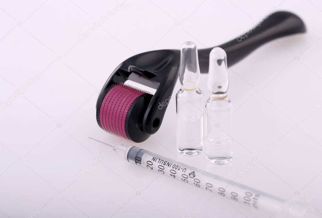 Derma roller for medical micro needling therapy with syringe and glass vial.Tool also known as: Dermaroller, mesoroller, meso-roller, mesopen.