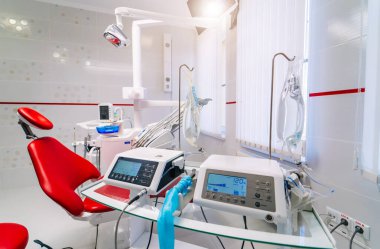 Medical equipment and stomatology concept - interior of new modern dental surgery clinic office with instruments.
