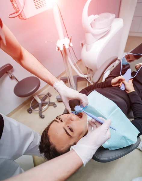 Dentist is treating female patient's teeth at stomatology chair. View from the top. Teeth health concept. — 图库照片