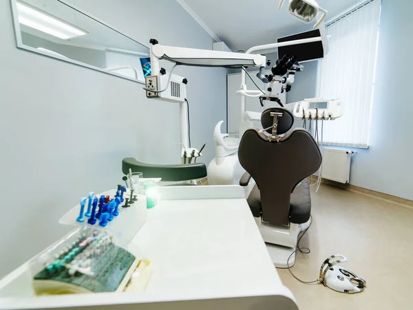 Brand new medical office. Advanced Dentist room with microscope. Stomatologist\' professional equipment. Hi tech medical clinic. Dentist clinic. Modern dental office interior.