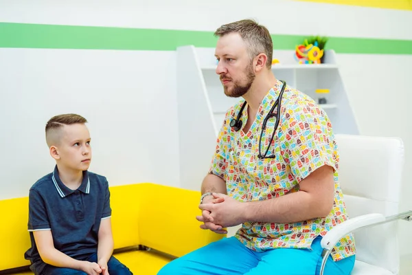 Attenzione pediatra consultando un bambino. Esame medico. Servizio medico. Medico uomo che dà edvizi e guida. Concetto pediatrico. Ragazzo è ascolto. — Foto Stock