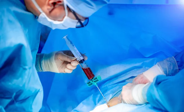 Kemik iliği nakli ameliyatı. Ameliyathanede çalışan tıp üniformalı ve maskeli cerrahlar..