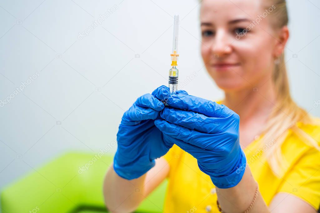 syringe with medicine in hand, for injection, prevention and health care concept.close-up