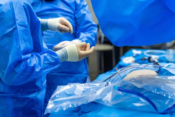 Surgery process. Group of surgeons in operating room with surgery equipment. Selective focus. Crop. Modern medical background. Closeup — Stock Photo, Image