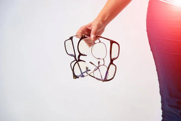 Spectacles closeup. Woman hand holds black framed eyeglasses. Fo — 스톡 사진