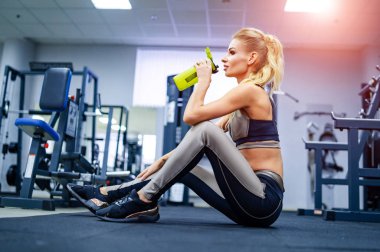 Young beautiful woman doing yoga or workout. Wellness concept. Single sports concept.