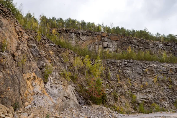 Large quarry, stepped terraced relief. Mining industry. Mine and quarry panorama. Abandoned quarry