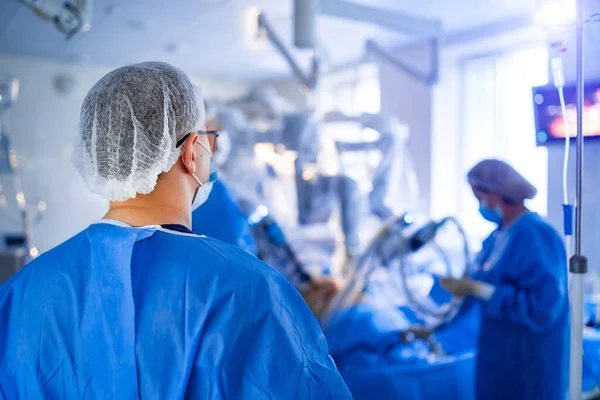 Modern equipment in operating room. Team surgeon at work in operating room. Surgeon in operating room with surgery equipment. Medical background.