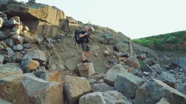 Traveler Backpack Shorts Black Shirt Sitting Large Rock Examining Beautiful — Stock Video