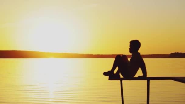 Little Boy Sitting Lotus Position Edge Bridge River Sunset Summer — Stock Video