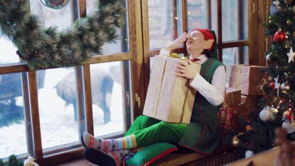 Tired Elf Long Ears Sitting Windowsill Gift His Hand Background — Stock Video