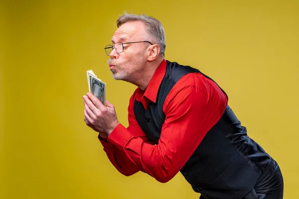 Man Holding Lots Dollar Bills Hands Isolated Yellow Background Happy — Stock Photo, Image