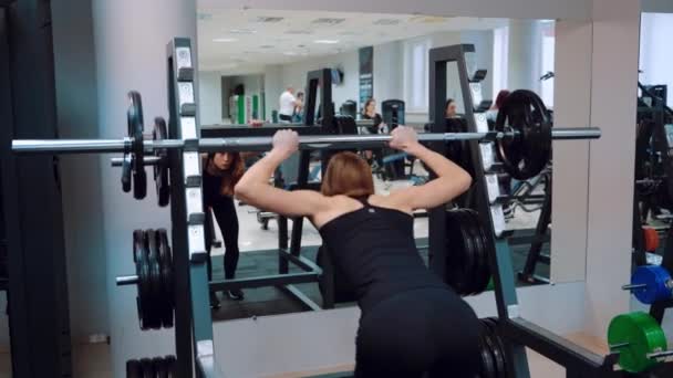 Slender Girl Black Sportswear Raises Barbell Crouches Background Mirror Fitness — Stock Video