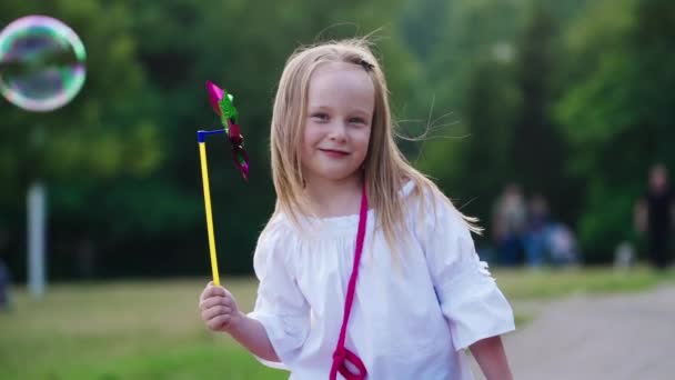Little Girl Playing Toy Pinwheel Little Girl Playing Pinwheel Outdoors — Stock Video