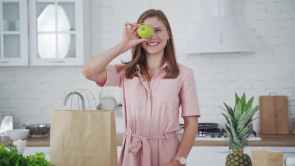 Kobieta Nowoczesnej Kuchni Urocza Dziewczyna Zabawy Jabłkiem Nowoczesnej Jasnobiałej Kuchni — Wideo stockowe