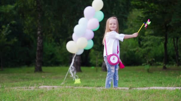Дитяча Дівчинка Тримає Вітрову Іграшку Красива Дівчина Тримає Вітрову Іграшку — стокове відео