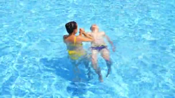 水泳プールで男の子と母親 スイミングプールで楽しい家族 — ストック動画