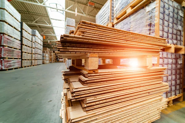 Wooden boards, lumber, industrial wood, timber. Pine wood timber stack of natural rough wooden boards on building site. Industrial timber building materials