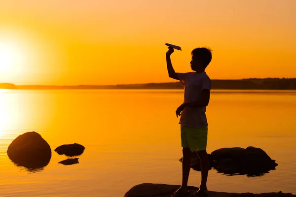 Teenie Junge Betrachtet Papierflugzeug Der Hand Bei Orangefarbenem Sonnenuntergang Die — Stockfoto