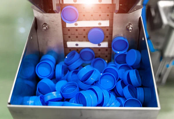 Blue plastic cups production. Equipment at the dairy plant. Packaging for milk products.