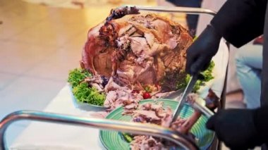 Garson misafirler için tavuk kesiyor. Garson müşteriye bir parça taze kızarmış tavuk verir.